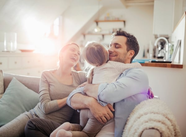 A happy family smiling while waiting for Heat Pump Maintenance in Dewitt, IA
